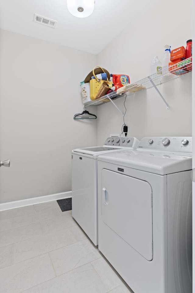 washroom with washer and dryer