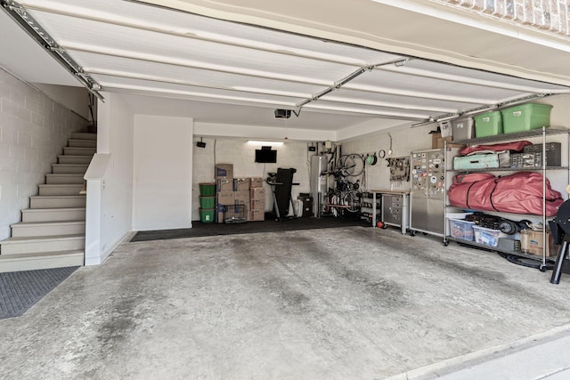 garage featuring a garage door opener and water heater