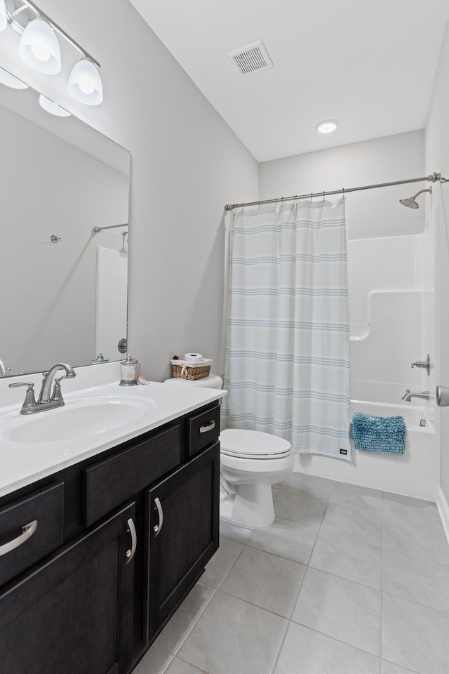 full bathroom with vanity, shower / bathtub combination with curtain, tile patterned floors, and toilet