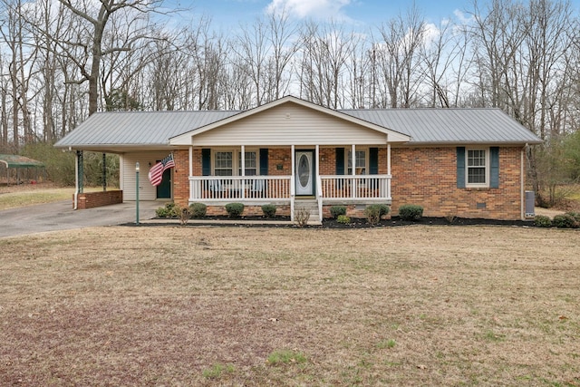 single story home featuring a carport, covered porch, and a front lawn