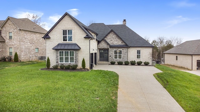 view of front of home featuring central AC unit and a front yard