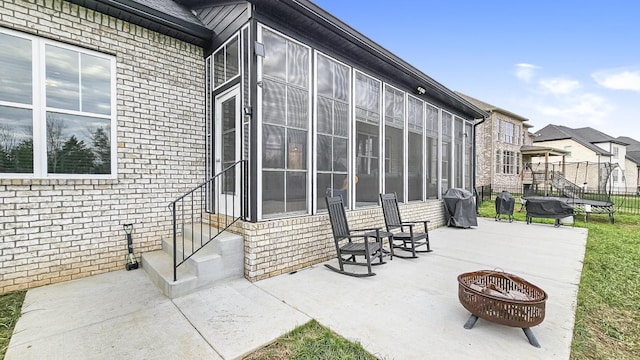 view of patio / terrace featuring area for grilling, a trampoline, and a fire pit