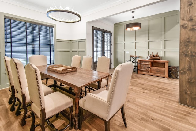 dining area featuring ornamental molding and light hardwood / wood-style floors