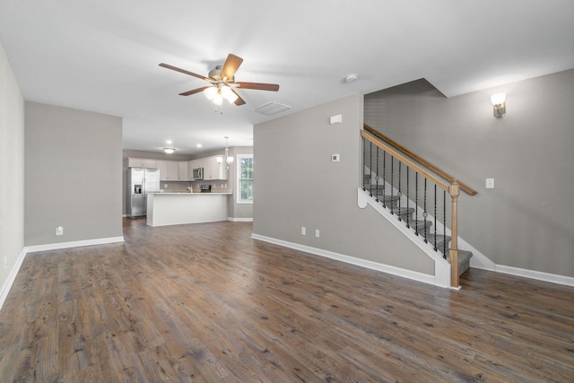 unfurnished living room with ceiling fan and dark hardwood / wood-style flooring