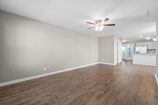 unfurnished living room with dark hardwood / wood-style floors and ceiling fan