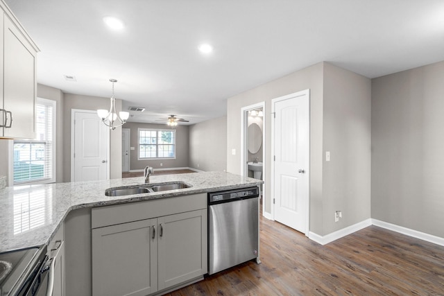 kitchen featuring sink, hanging light fixtures, stainless steel appliances, light stone counters, and dark hardwood / wood-style flooring