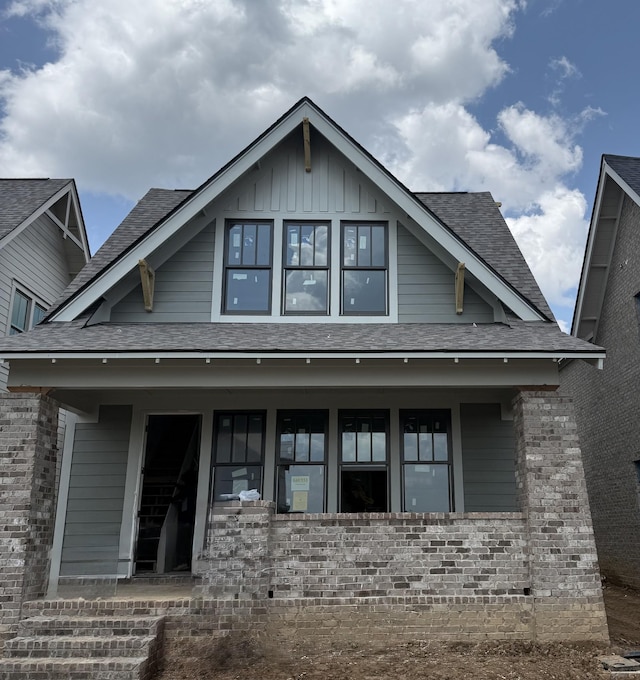318 Huron Dr, Spring Hill, TN 37174 - view of front of home with roof with shingles, board and batten siding, brick siding, and a porch