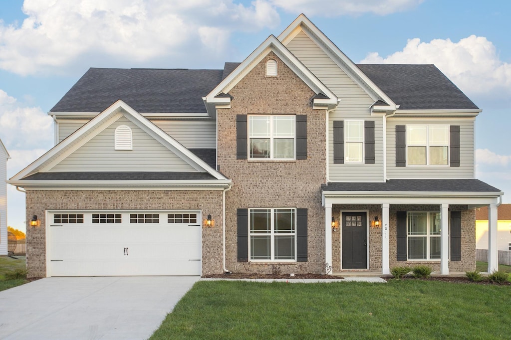 craftsman-style home with a garage and a front lawn