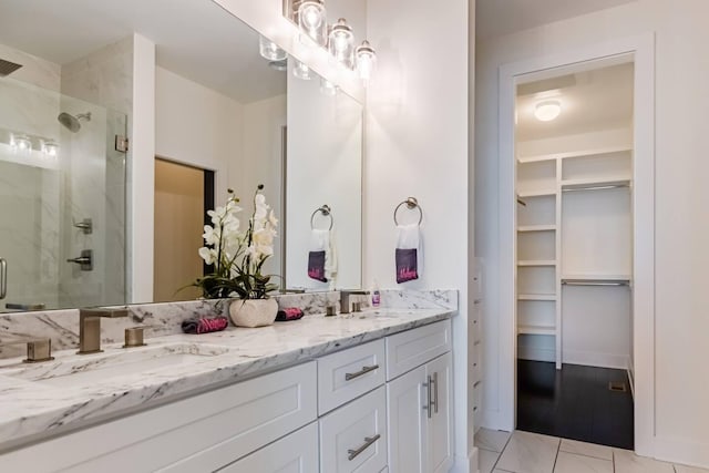 bathroom with vanity and a shower with door