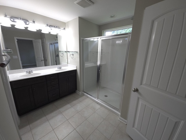 bathroom with vanity, tile patterned flooring, and a shower with door