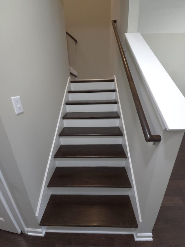 staircase with wood-type flooring