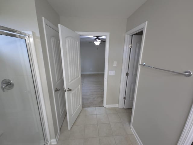 bathroom featuring tile patterned flooring, ceiling fan, and walk in shower