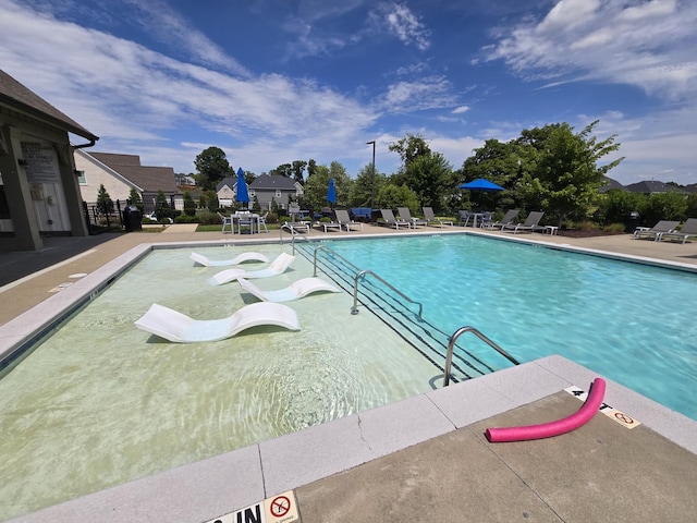 view of swimming pool featuring a patio area