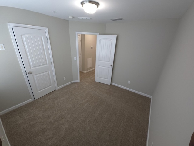 unfurnished bedroom with carpet floors