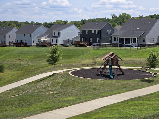 view of property's community featuring a playground and a lawn