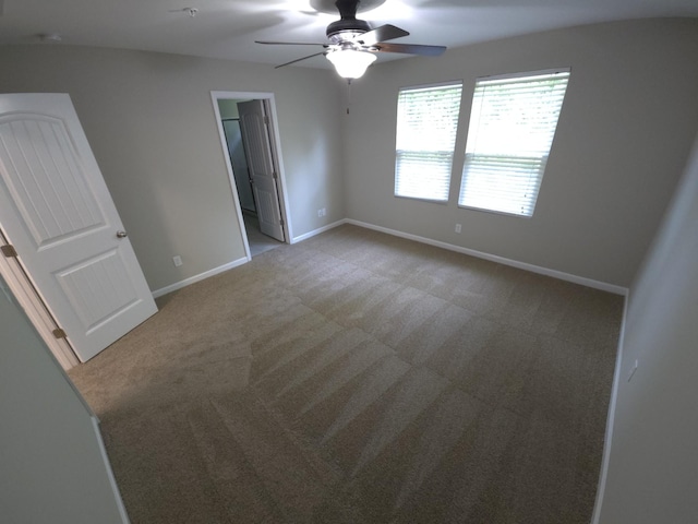 carpeted spare room with ceiling fan