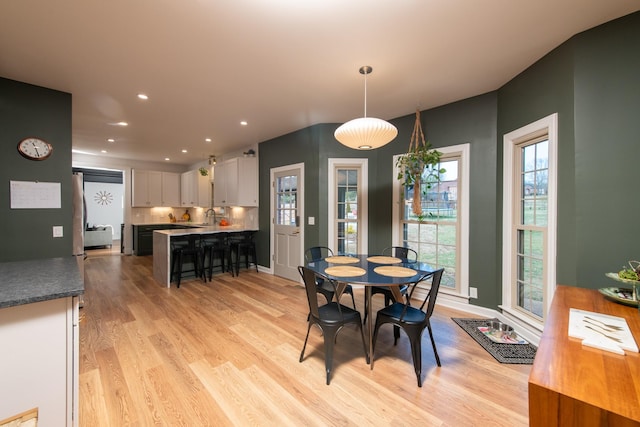 dining area featuring sink and light wood-type flooring