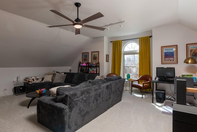 living room featuring vaulted ceiling, rail lighting, light carpet, and ceiling fan