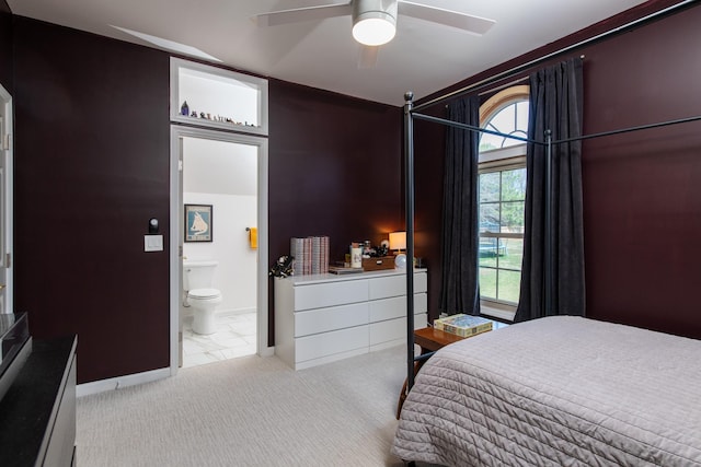 bedroom featuring light carpet, connected bathroom, and ceiling fan