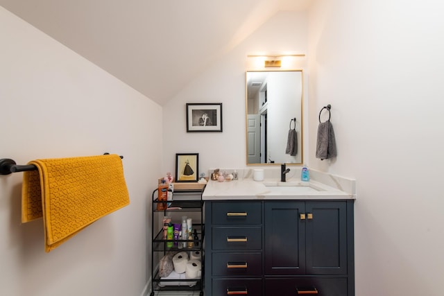 bathroom with vanity and lofted ceiling