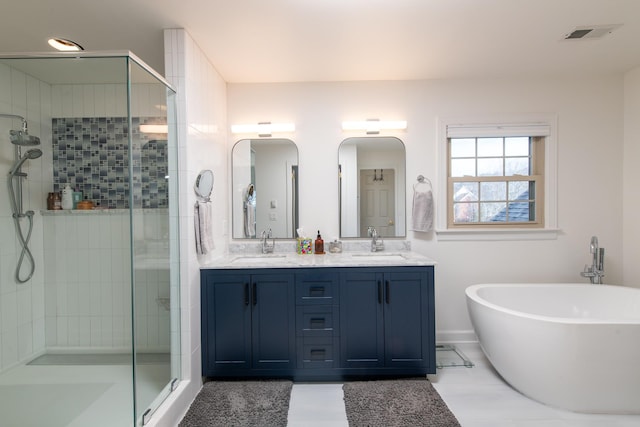 bathroom with vanity and separate shower and tub