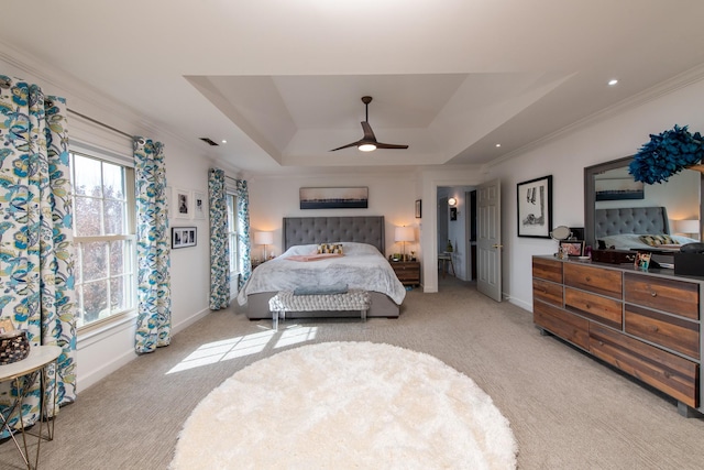 carpeted bedroom featuring a raised ceiling, crown molding, and ceiling fan