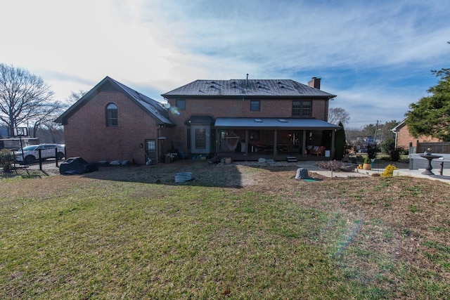 rear view of property featuring a yard