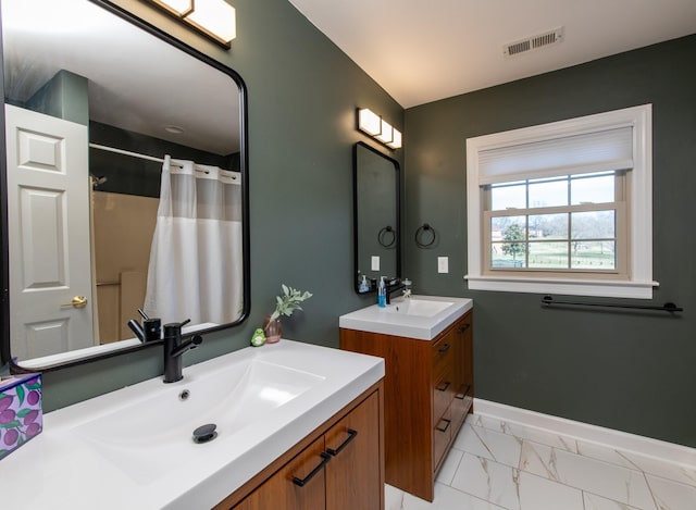 bathroom with walk in shower and vanity