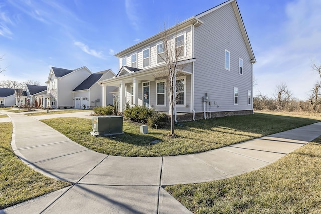 view of front facade featuring a garage, covered porch, and a front lawn