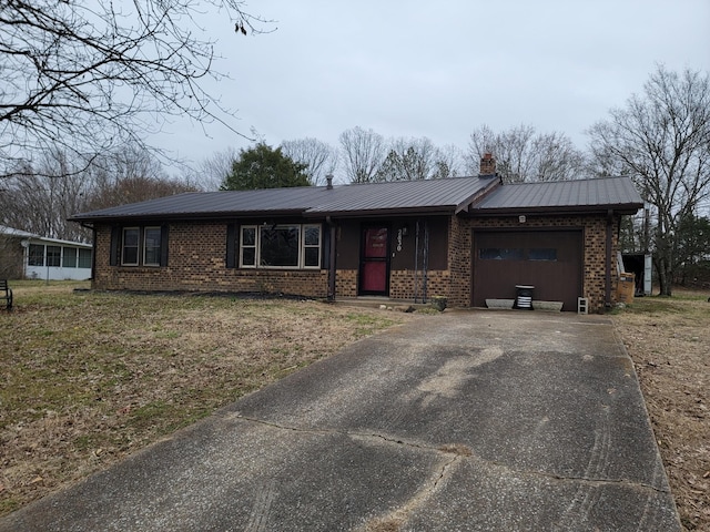 single story home with a garage and a front yard