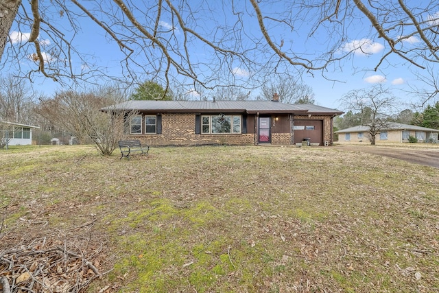 single story home featuring a garage and a front lawn