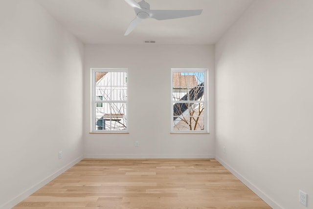 spare room with ceiling fan and light wood-type flooring