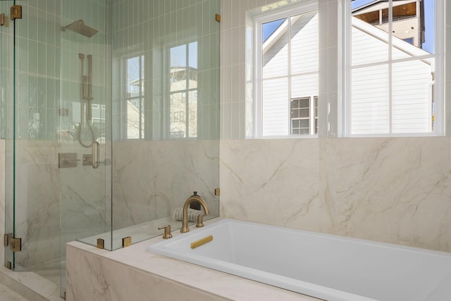 bathroom with plus walk in shower and tile walls