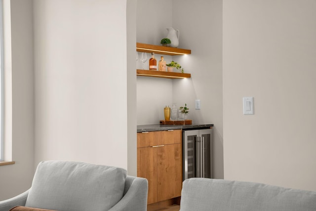 bar featuring hardwood / wood-style flooring and beverage cooler