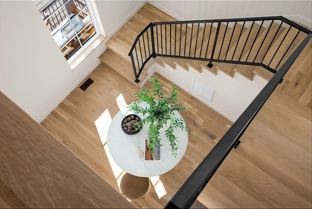 stairs with hardwood / wood-style floors