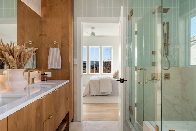 bathroom featuring ceiling fan, tile patterned floors, vanity, and a shower with door