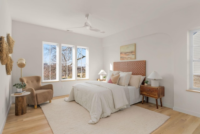 bedroom with ceiling fan and light hardwood / wood-style floors