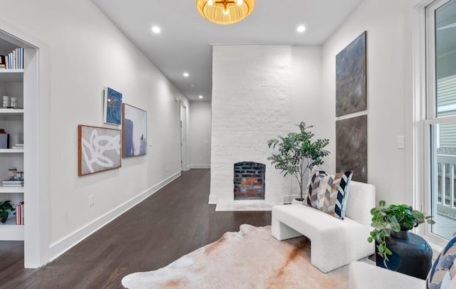 hallway featuring built in features and dark hardwood / wood-style flooring