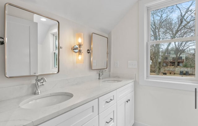 bathroom featuring vanity and lofted ceiling