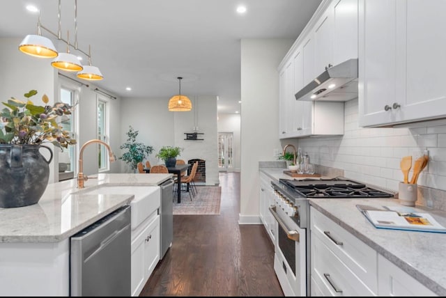 kitchen with white cabinetry, decorative light fixtures, dishwasher, and high end stove