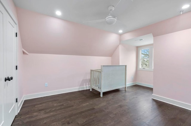 additional living space with lofted ceiling, dark hardwood / wood-style floors, and ceiling fan