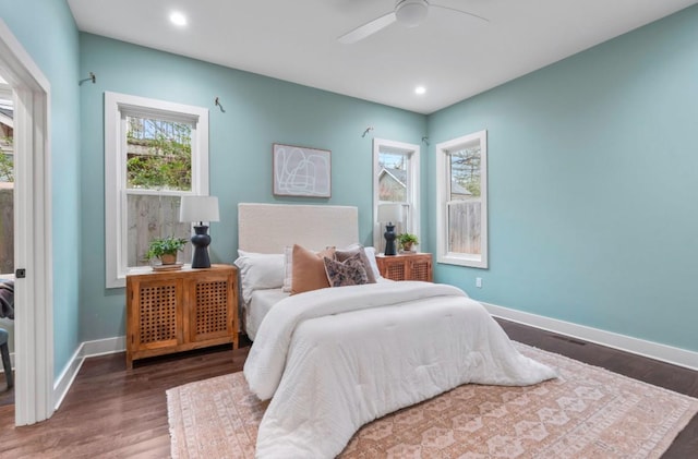 bedroom with ceiling fan and dark hardwood / wood-style floors