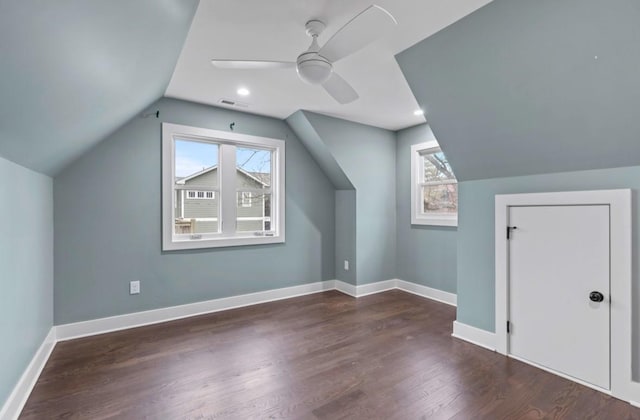 bonus room featuring a wealth of natural light, dark hardwood / wood-style floors, ceiling fan, and vaulted ceiling