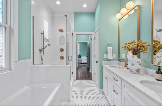 bathroom featuring vanity and shower with separate bathtub