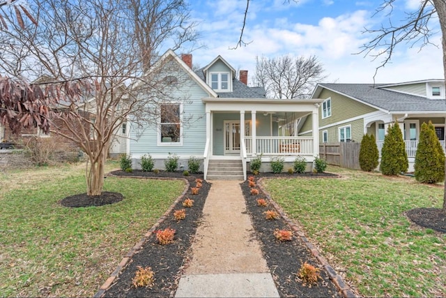 view of front of home with a front lawn and covered porch