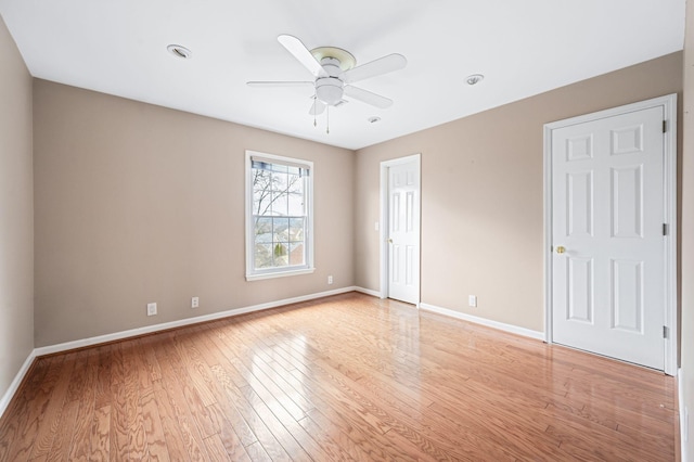 unfurnished room with ceiling fan and light wood-type flooring