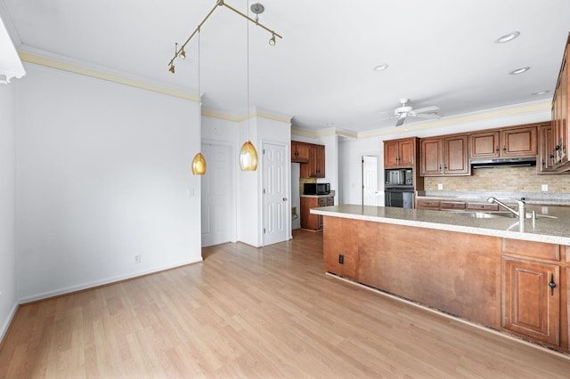 kitchen featuring sink, light hardwood / wood-style floors, ceiling fan, ornamental molding, and decorative backsplash