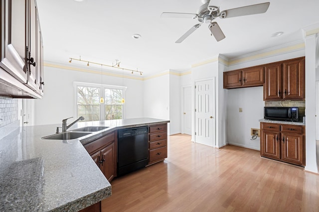 kitchen featuring light wood-type flooring, sink, black appliances, and tasteful backsplash