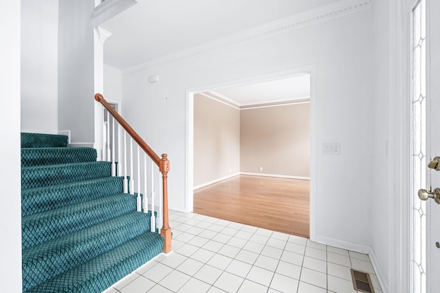 tiled foyer with crown molding