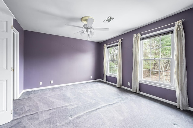 spare room with light carpet and ceiling fan